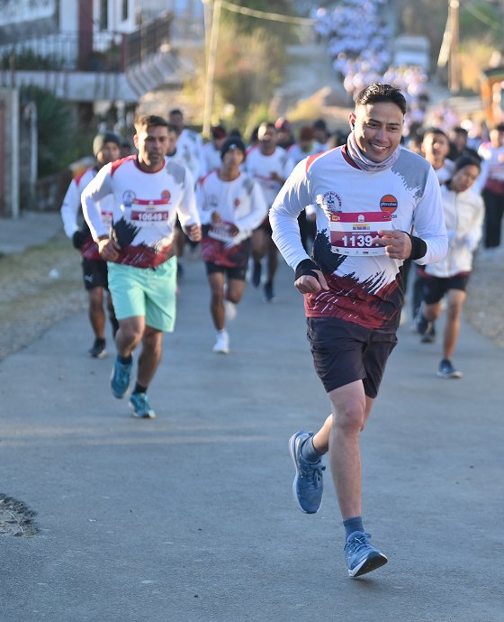 A runner on a hill road during the Assam Rifles Half Marathon in Shillong